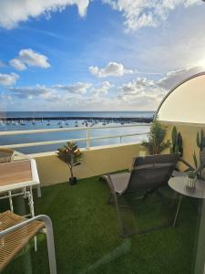 a chair on a balcony with a view of the water at La petite Croisière - Vue Mer in Jard-sur-Mer +39 photos