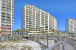 a building on the beach with a bridge and buildings at Beach Club unit 502C- Catalina in Gulf Highlands