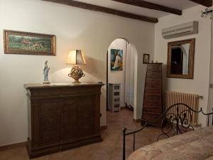 a bedroom with a dresser with a lamp on it at BlueHorizon in Santa Teresa di Riva