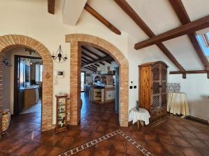 a large room with two arches and a kitchen at BlueHorizon in Santa Teresa di Riva