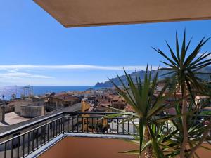 a balcony with a view of a city at BlueHorizon in Santa Teresa di Riva