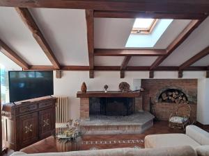a living room with a fireplace and a flat screen tv at BlueHorizon in Santa Teresa di Riva