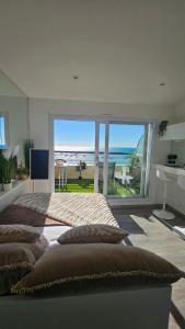a bedroom with a large bed with a view of the ocean at La petite Croisière - Vue Mer in Jard-sur-Mer