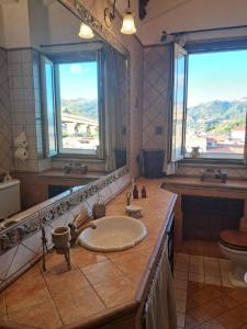 a bathroom with a sink and a large mirror at BlueHorizon in Santa Teresa di Riva +48 photos