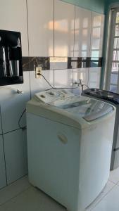 a kitchen with a washing machine and a stove at Ninho dos falcões in Nobres