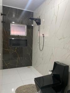a bathroom with a shower with a black and white at Ninho dos falcões in Nobres