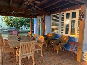 a wooden table and chairs on a patio at Beachfront Spacious Home Private Luxury Pool in Rio Grande