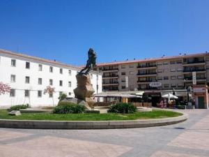 a statue of a woman on a rock in front of a building at Céntrico in Antequera