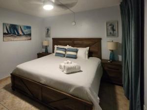 a bedroom with a large bed with a towel on it at Beachfront Spacious Home Private Luxury Pool in Rio Grande