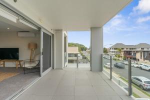 an open balcony with a view of a street at Spacious apartment in Mount Maunganui in Mount Maunganui