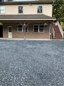 a house with a large driveway in front of it at Peaceful Mountain Farm in Honey Brook +5 photos