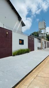 a white building with a brown and white wall at Salinas in Salinópolis