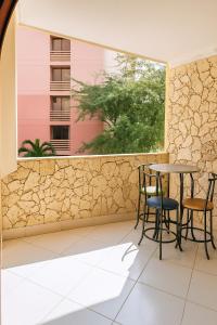 a patio with a table and chairs and a window at El Velero Apartamentos By DANP in Santa Marta