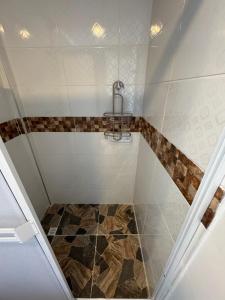 a bathroom with a shower with a tile floor at Posada ontimeview in Providencia +46 photos