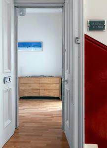 an open door leading to a bedroom with a dresser at Above The Bay in Port Bannatyne