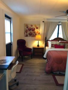 a bedroom with a bed and a chair and a table at Cozy private room in Princeton +7 photos