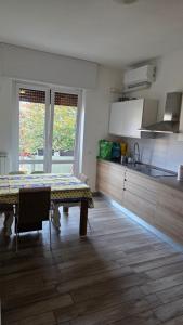a room with a table and a kitchen with a tableablish at Rocca view central flat in Arona