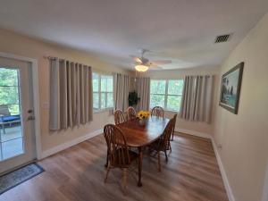 a dining room with a table and chairs at Life at the lake in Inverness +20 photos