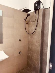a shower with a shower head in a bathroom at Bright 3-Bed Flat with Balcony with Great Value in Sri Jayewardenepura Kotte +22 photos