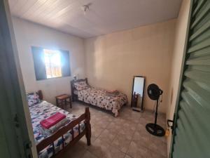 a bedroom with two beds and a mirror at MAEVE Hostel in Goiás