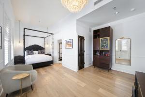 a bedroom with a bed and a chair and a mirror at Fairmount Hotel in San Antonio +114 photos