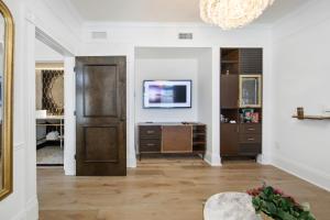 a living room with a door and a tv at Fairmount Hotel in San Antonio