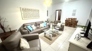 a living room with a couch and a table at Menendez Bohemian Dreams by Deihu Experiences in Los Cristianos