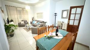 a living room with a table and a couch at Menendez Bohemian Dreams by Deihu Experiences in Los Cristianos