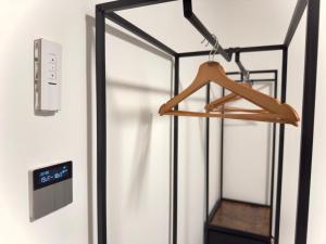 a glass door with a hanger on a wall at Ferienwohnung In Der Grafschaft in Altendorf