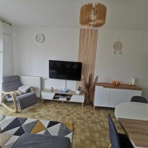 a living room with a flat screen tv on a wall at 2 chambres dans Appartement cozy in Rodez +24 photos