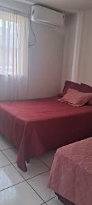 a bedroom with two beds and a window at Conforto e Lazer no Coração da Ilha de São Luís in São-José-do-Ribamar