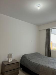a bedroom with a bed and a window at Departamento céntrico en estreno in Arequipa