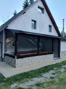 a house being remodeled with a large window at Star Panzió in Harghita-Băi
