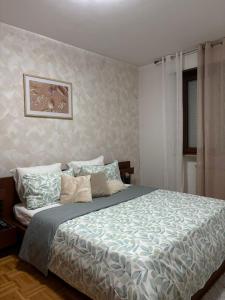a bedroom with a bed with a blue comforter at Calvo in Ronchi dei Legionari