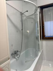 a shower with a glass door in a bathroom at Calvo in Ronchi dei Legionari +15 photos