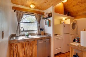 a kitchen with a sink and a refrigerator at Unwind Poolside, Scenic Sonoran Desert Retreat! in Tucson