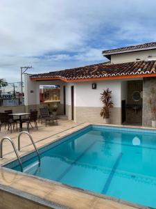 a swimming pool in front of a house at Hotel Terra Mater in Porto Seguro