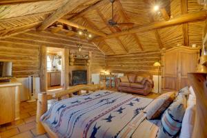 a bedroom with a large bed in a log cabin at Unwind Poolside, Scenic Sonoran Desert Retreat! in Tucson