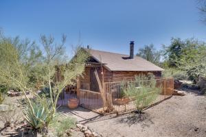 a log cabin with a fence in the desert at Unwind Poolside, Scenic Sonoran Desert Retreat! in Tucson
