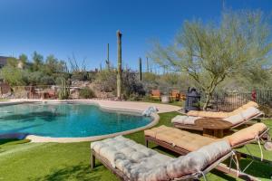 a swimming pool with lounge chairs and a table and a poolificialificialificialificial at Unwind Poolside, Scenic Sonoran Desert Retreat! in Tucson
