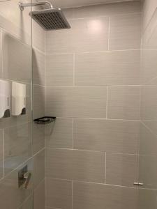 a bathroom with a shower with a glass door at Hotel Poblado Boutique in Medellín +21 photos