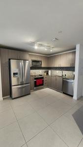 a large kitchen with stainless steel appliances and cabinets at acogedor apartamento en centro in Miami