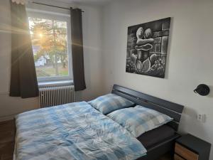 a bedroom with a bed and a window at Apartmán 28 in Horní Město