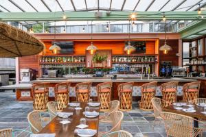 a restaurant with tables and chairs and a bar at W Los Angeles – West Beverly Hills in Los Angeles