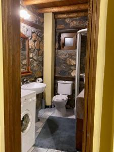 a bathroom with a toilet and a sink at Elato Stone House in Panayítsa +14 photos