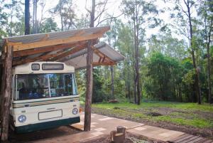 a food truck with a shelter on top of it at Coffee Grounds - The Coach in Coffee Camp