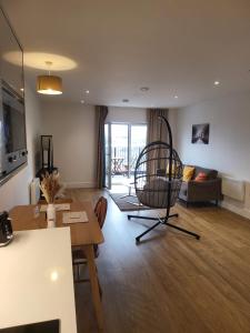 a living room with a chair and a table at One Bedroom Flat in the Heart of Birmingham in Birmingham
