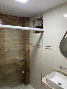 a bathroom with a shower and a sink at Pousada Flor do Sol in Fortaleza