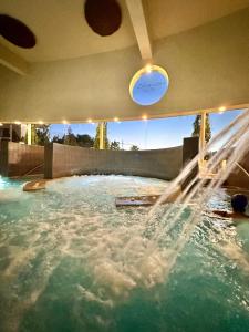 a water slide in a swimming pool with a frisbee at Boutique Higueron Spa in Fuengirola
