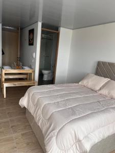 Ένα ή περισσότερα κρεβάτια σε δωμάτιο στο Apartaestudio suite Murango